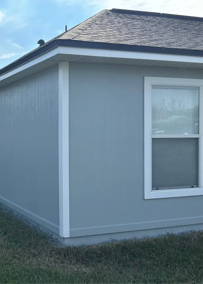 Professional exterior home makeover by 1st Coast Painting featuring fresh light blue siding and crisp white trim for enhanced curb appeal.