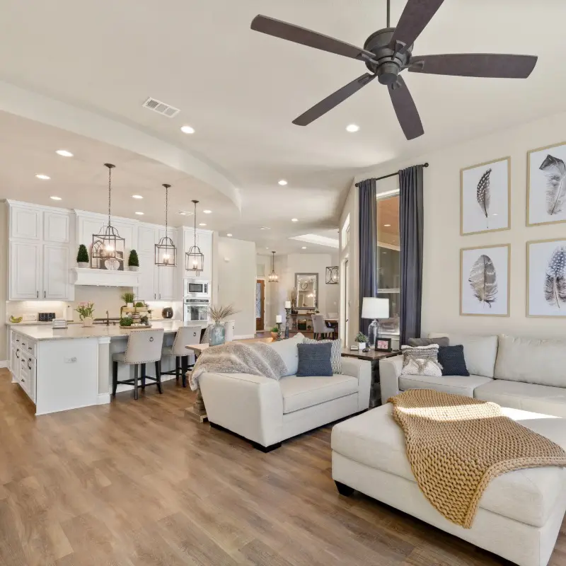 Spacious open-concept interior featuring warm wood flooring and expertly finished neutral walls, highlighting the residential craftsmanship of 1st Coast Painting.