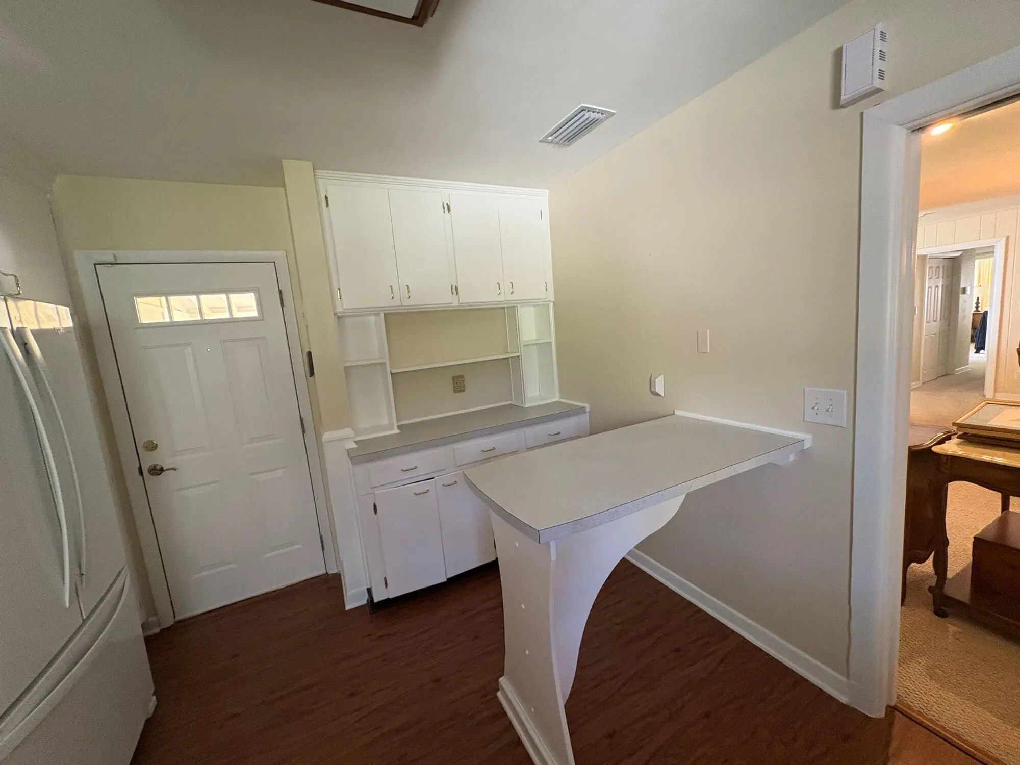 Functional home workspace featuring fresh white cabinetry and a minimalist built-in desk, expertly refreshed by 1st Coast Painting.
