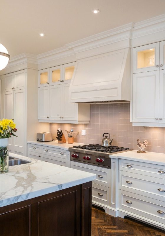 Gourmet kitchen upgrade featuring luxury white cabinetry and a marble island, showcasing the precision interior finishing of 1st Coast Painting.